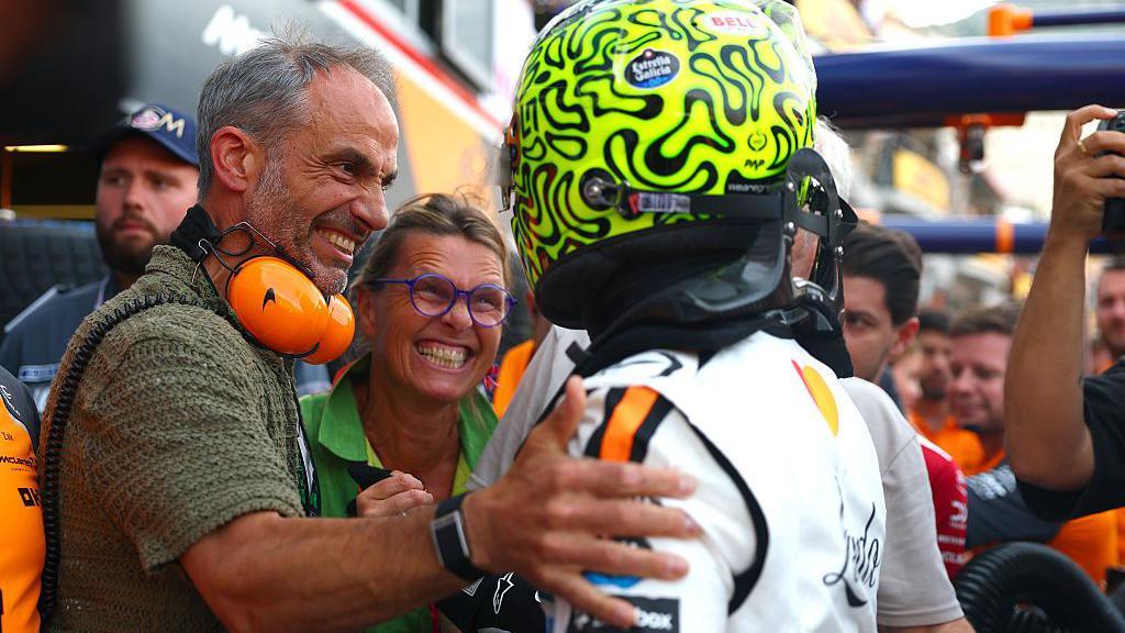 McLaren's Lando Norris celebrates in parc ferme with his parents after the qualifying session.