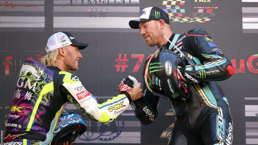 Race winner Peter Hickman greets Davey Todd on the podium