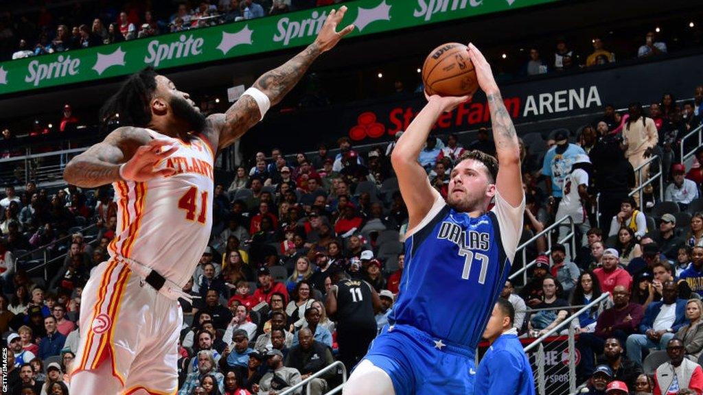 Luka Doncic prepares to throw the ball at the basket against the Atlanta Hawks