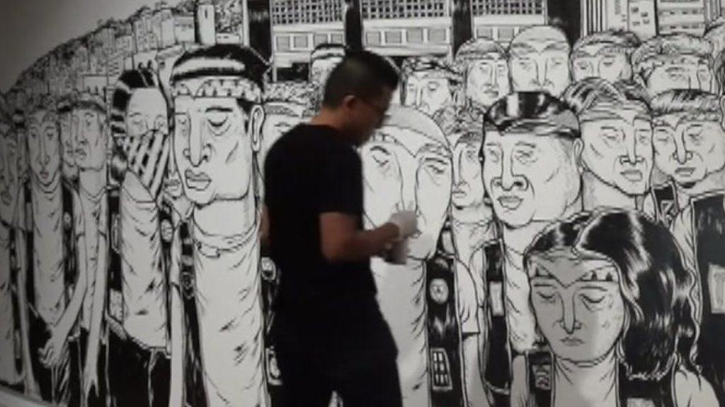 Singapore street artist with his artwork