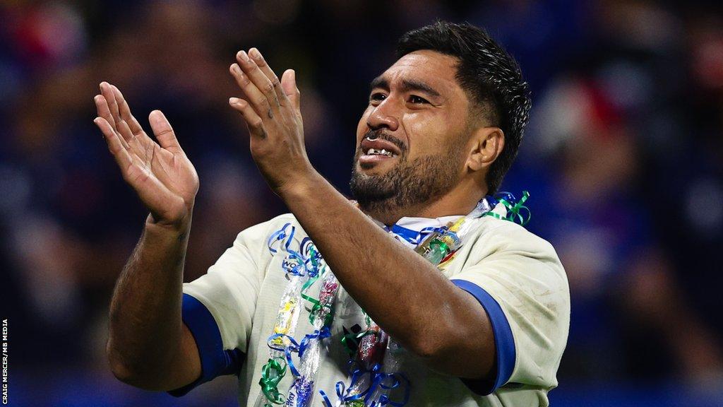 Hame Faiva applauds towards fans after a World Cup match