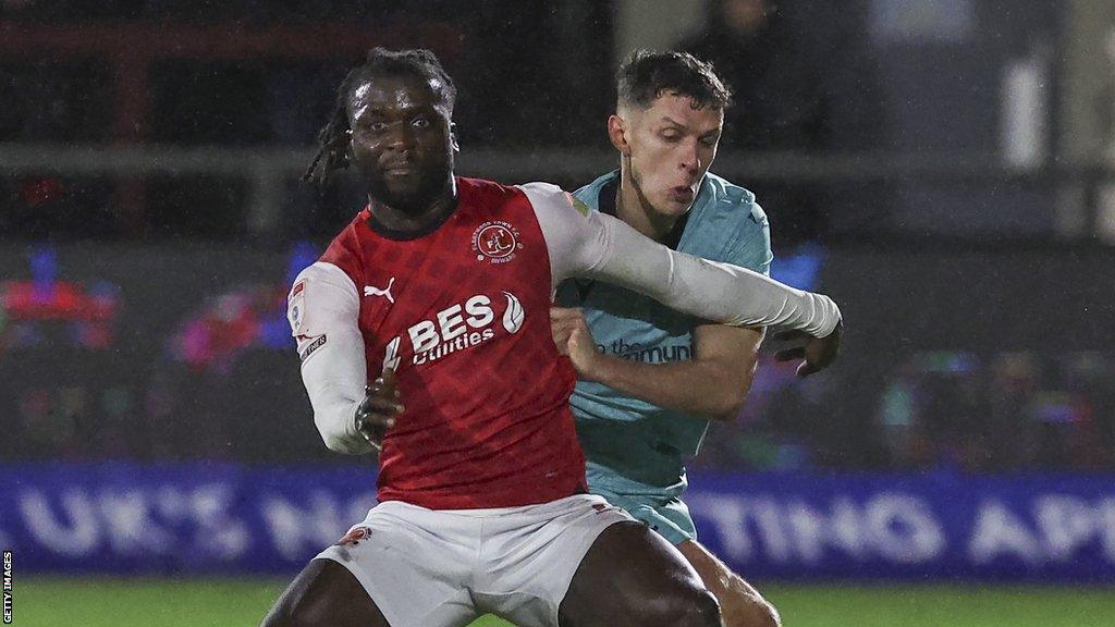 Fleetwood Town's Junior Quitirna shields the ball from Bolton Wanderers' Eoin Toal during the League One match at Highbury Stadium on December 29, 2023