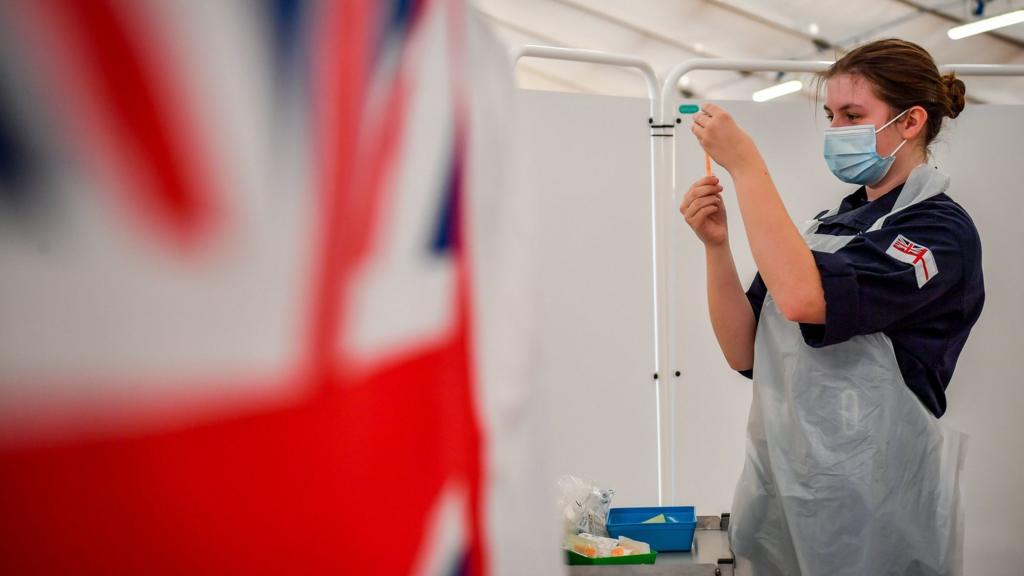 Royal Navy personnel prepare to give vaccines to the public at a coronavirus vaccination centre set up at Bath Racecourse