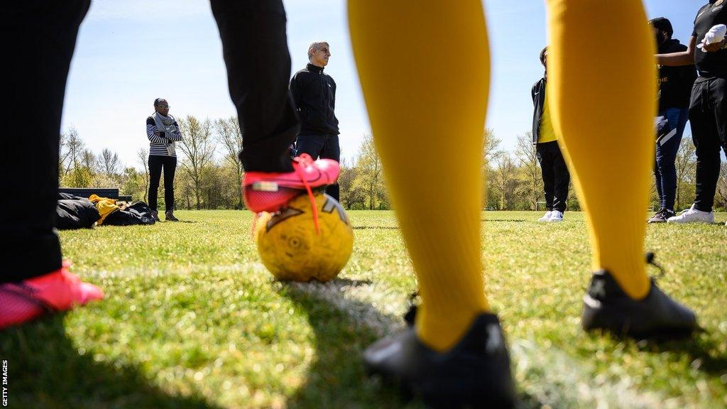 Footballers prepare to train at a grassroots sport event