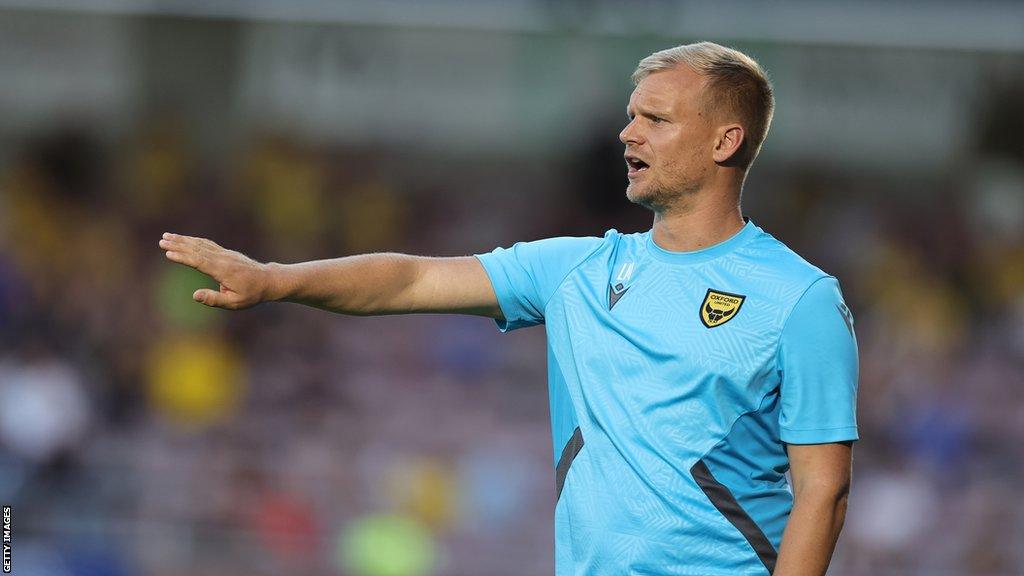 Oxford United boss Liam Manning gives his team instructions from the touchline during a League One match.