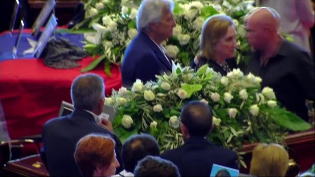 Mourners stand alongside coffins at the state funeral in Genoa, Italy, on 18 August 2018.