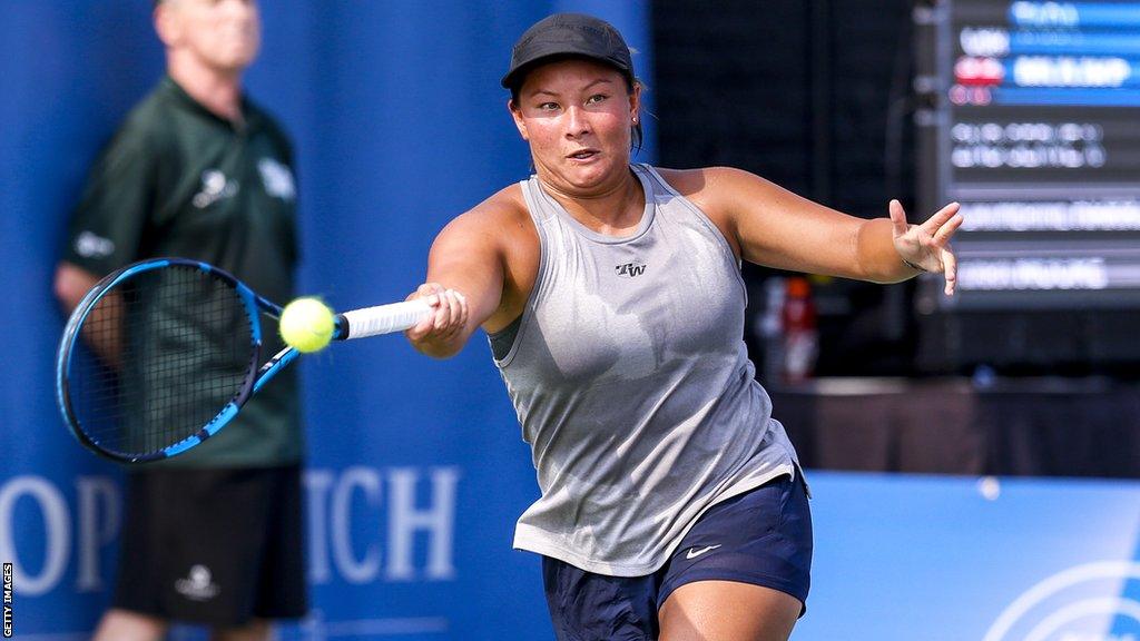 Tennis player Tara Moore plays a shot