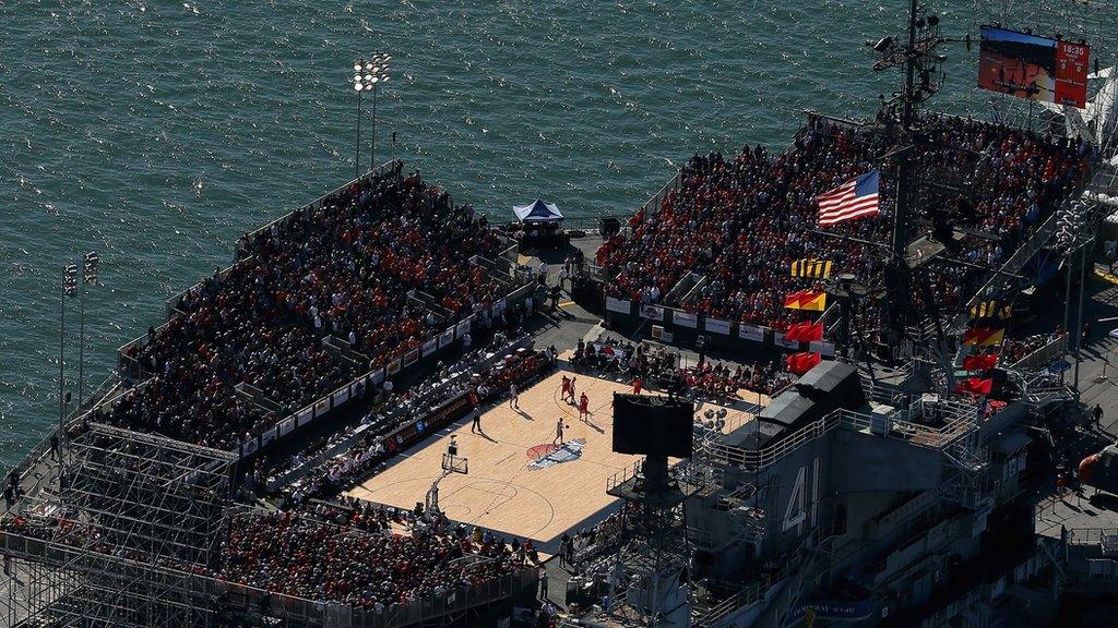 A basketball match played on an aircraft carrier out at sea.