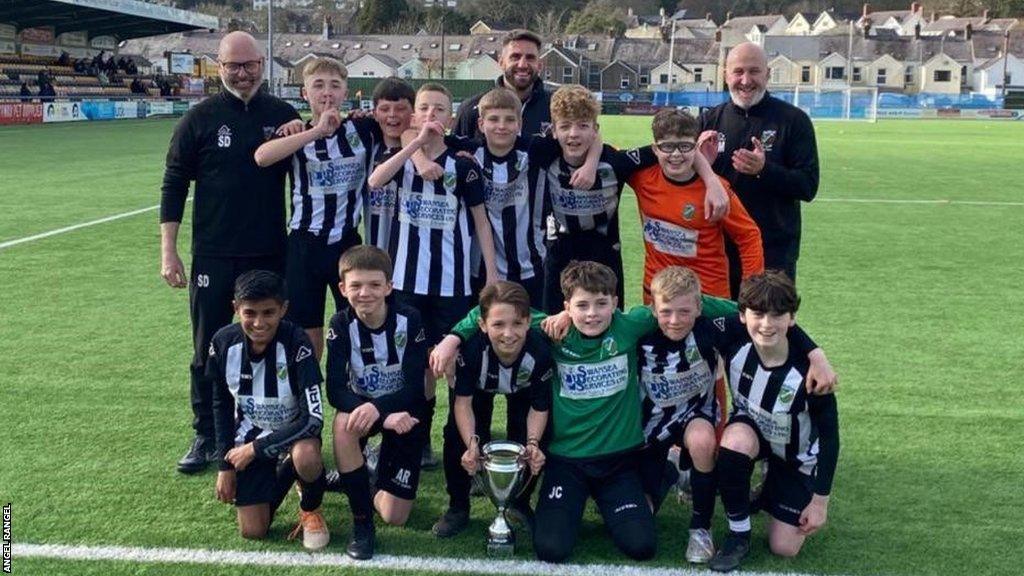 Angel Rangel with his Pontardawe Town Under-12s team and coaches Gary Moorhouse and Steve Dix