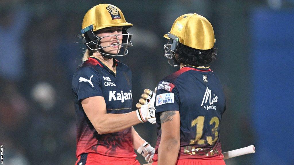 RCB batters Ellyse Perry (left) and Richa Ghosh (right) celebrate winning the WPL