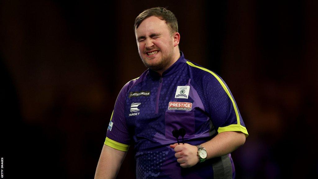 Luke Littler celebrates on the oche