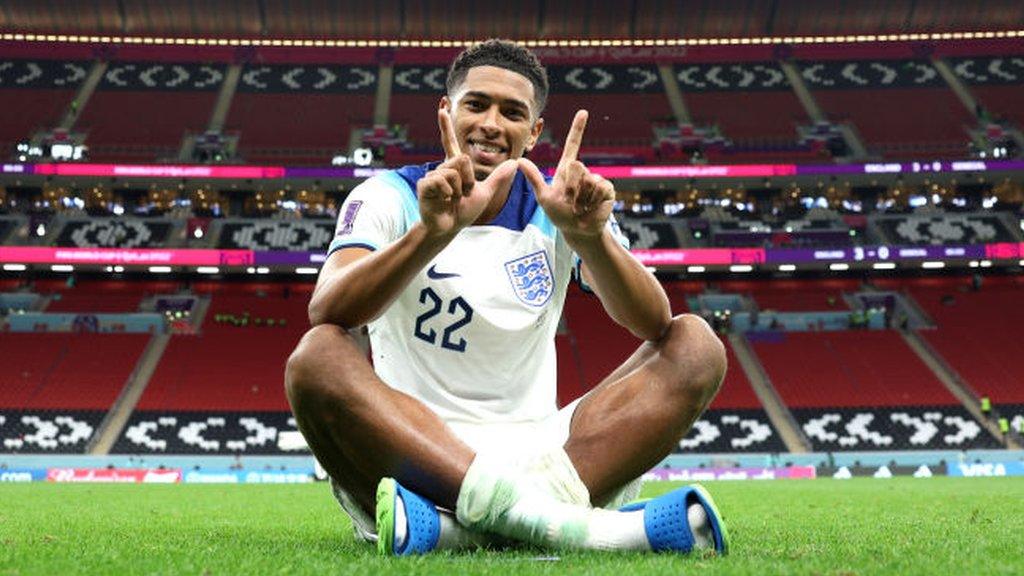 Jude Bellingham sits on the pitch after England beat Senegal