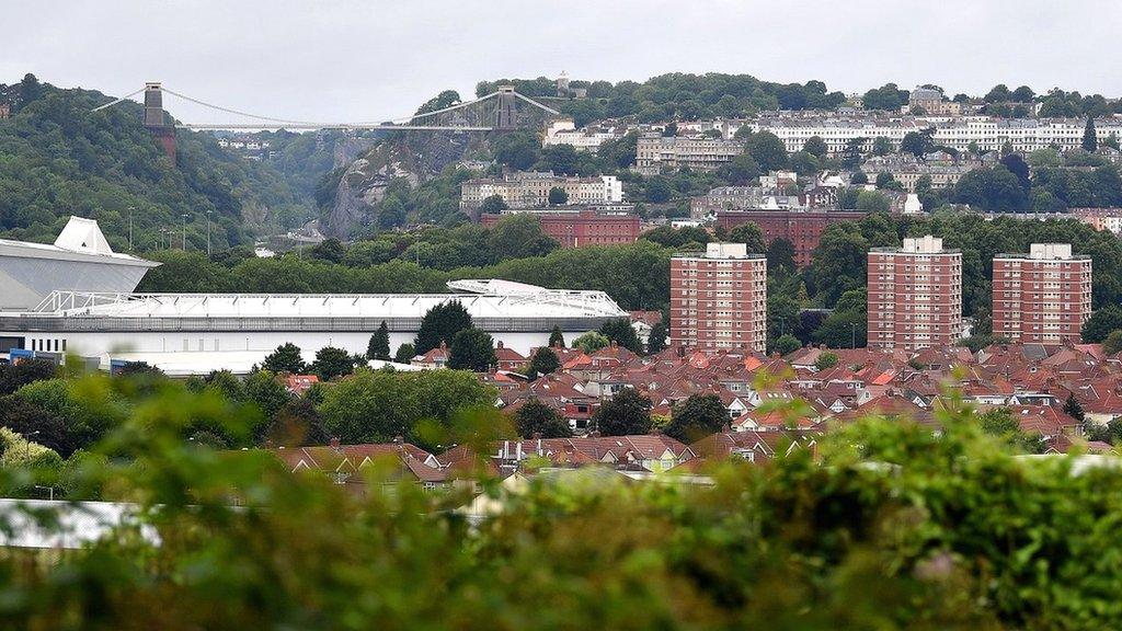 A wide view of Bristol with Ashton Gate stadium in the foreground and the Clifton Suspension Bridge in the background