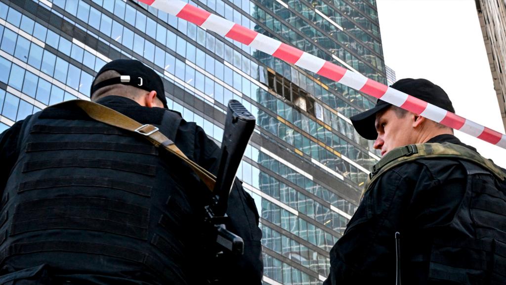 Police officers block off an area around a damaged office block of the Moscow International Business Center following a reported drone attack in Moscow on 1 August 2023
