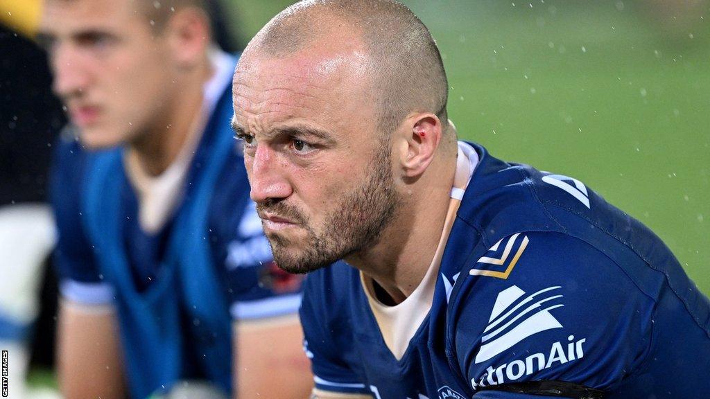 Josh Hodgson sits on the bench looking disappointed while with Parramatta