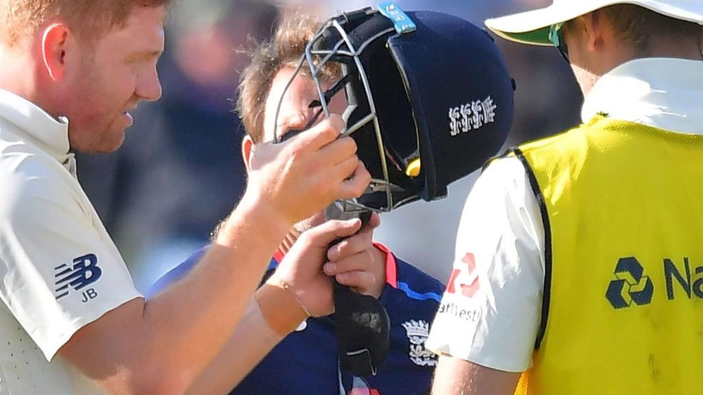 Jonny Bairstow inspects his helmet