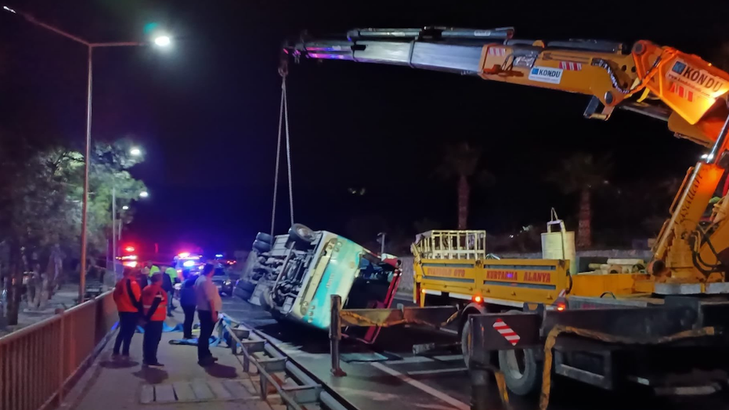 An emergency rescue vehicle moves the overturned bus which was carrying the Alanya Kestelspor team