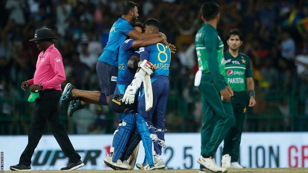 Sri Lanka players jump on each other in celebration after beating Pakistan