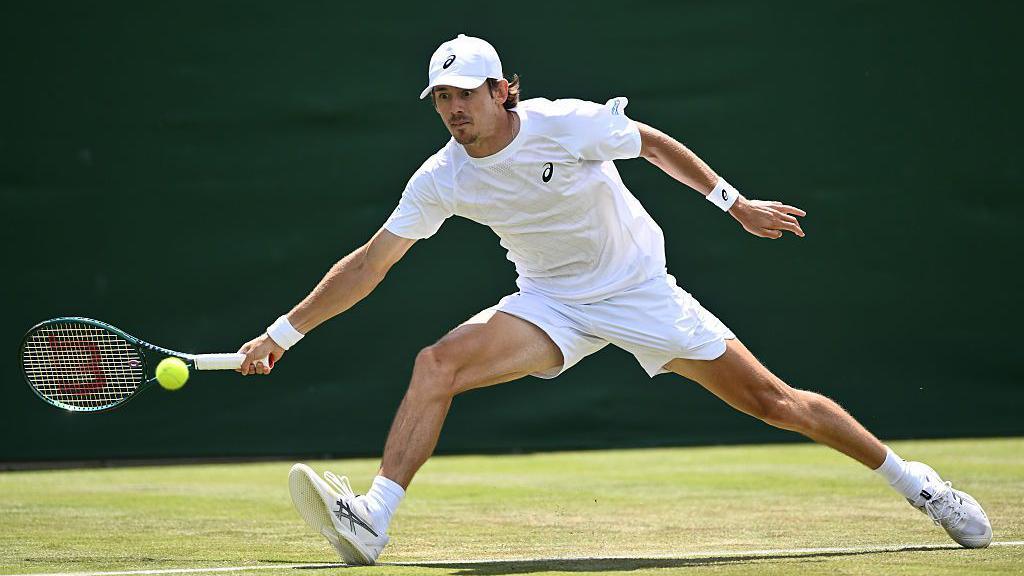 Alex de Minaur stretches to connect with a forehand