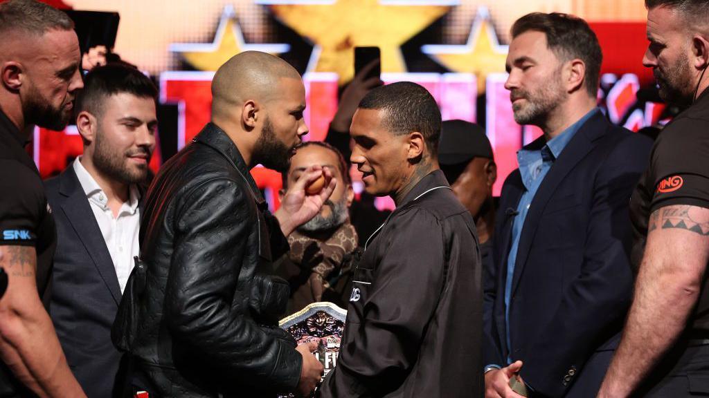 Chris Eubank holds an egg in his hand before slapping Conor Benn across the face with it