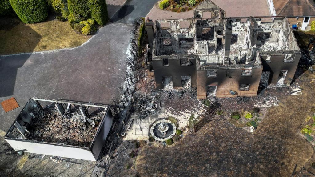 A drone view of burnt-out houses following a large grass fire which spread to several homes yesterday during the hottest day of the year, in Stourbridge, West Midlands