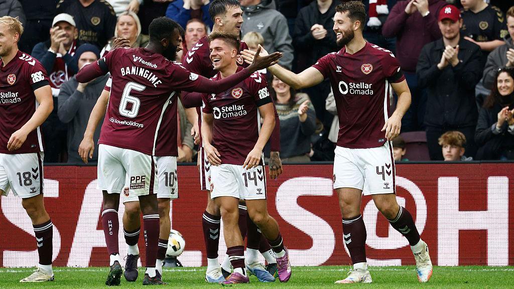 Hearts players celebrating on the pitch.