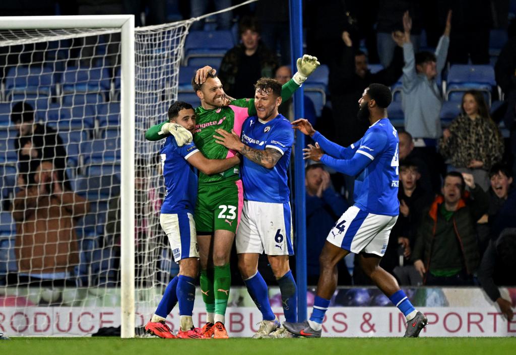 Ryan Boot of Chesterfield celebrates with teammates after saving a penalty during the Sky Bet League Two match between Chesterfield FC and Grimsby Town at Proact Stadium on April 14, 2026 in Chesterfield, England.