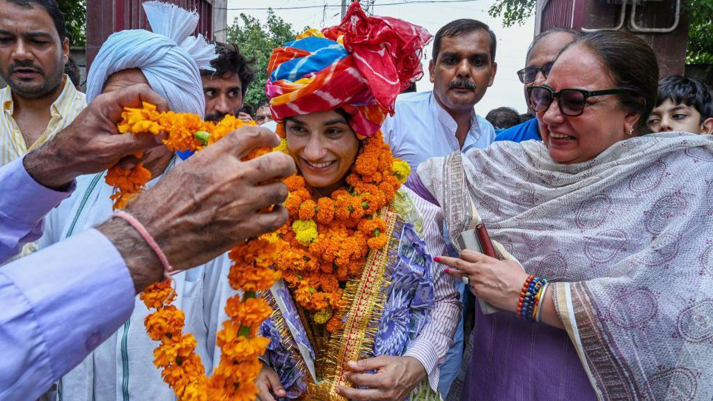 Wrestler Vinesh Phogat upon her arrival at IGI airport from Paris after a historic performance at the Paris Olympics 2024 at IGI Airport, she was received by Bajrang Punia, Sakshi Malik and panchayat leaders, on August 17, 2024 in New Delhi, India.