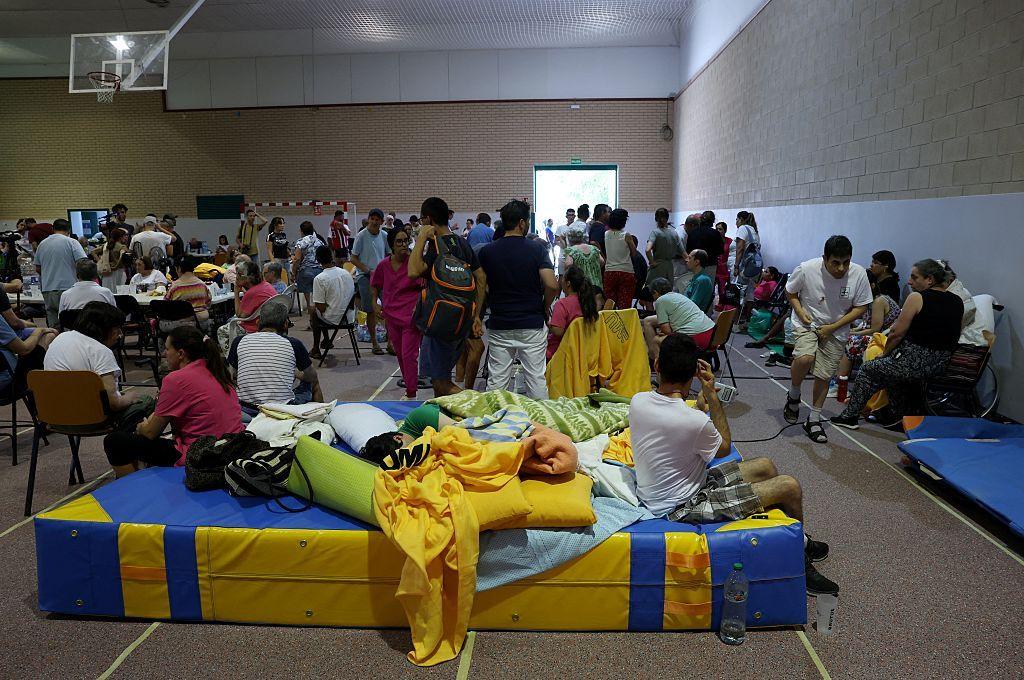 Residents evacuated from a wildfire adjacent   San Martin de Valdeiglesias instrumentality     structure  successful  a sportshall successful  Villamanta, westbound  of Madrid.