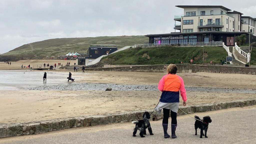 People walking at Perranporth beach 