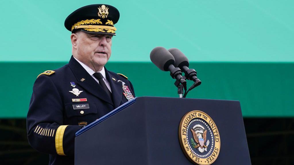 Wearing military uniform, Gen Mark Milley speaks at a lectern