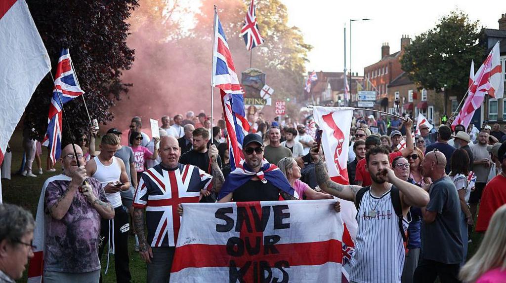 Protesters calling for the closure of the Bell Hotel gather outside the council offices in Epping on 8 August 2025.