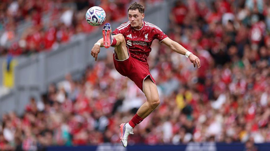 Florian Wirtz acrobatically controls the ball while playing for Liverpool
