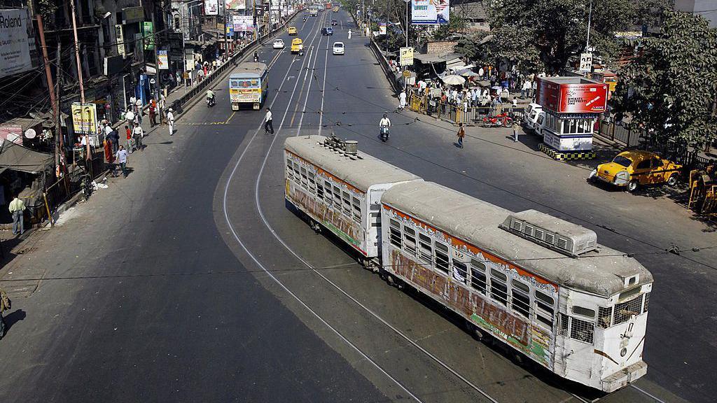 A tram rolls along a main road which is usually jammed with traffic, during a 12-hour general strike in Kolkata on January 22, 2009. 