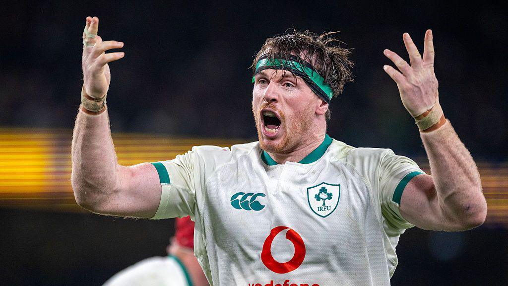 Ryan Baird raises his hands in celebration