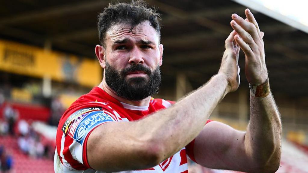 St Helens prop Alex Walmlsey applauds the fans