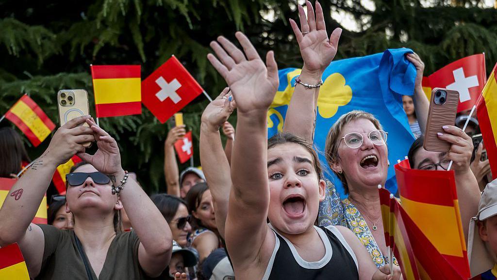 Fans wave Spanish flags in Lausanne