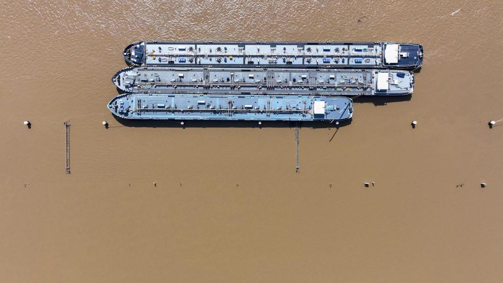 Anchored barges on the River Rhine next to the BASF SE industrial plant and flooded floodplains in Ludwigshafen, Germany, on Monday, June 3, 2024