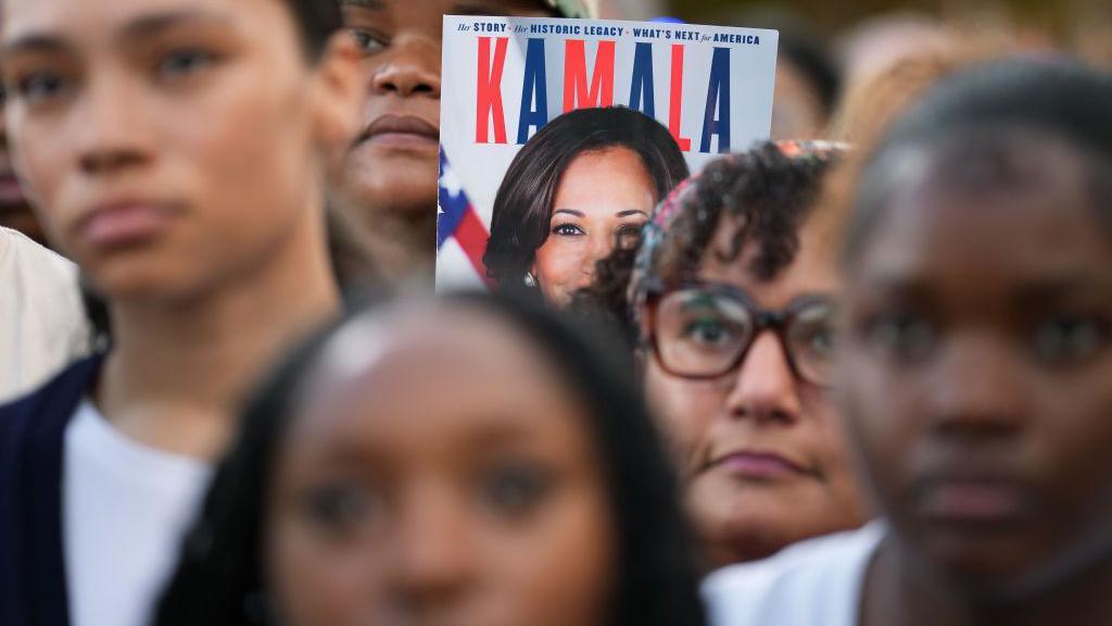 A supporter holds up a sign with Democratic presidential nominee, U.S. Vice President Kamala Harris as she concedes the election during a speech at Howard University on November 06, 2024 in Washington, DC