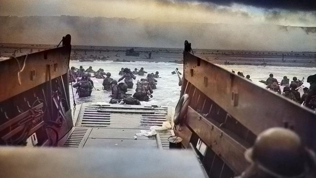 A photograph by Robert F Sargent of the United States Army First Infantry Division disembarking from an LCVP (landing craft) onto Omaha Beach during the Normandy Landings on D Day during World War 2, June 6, 1944. 