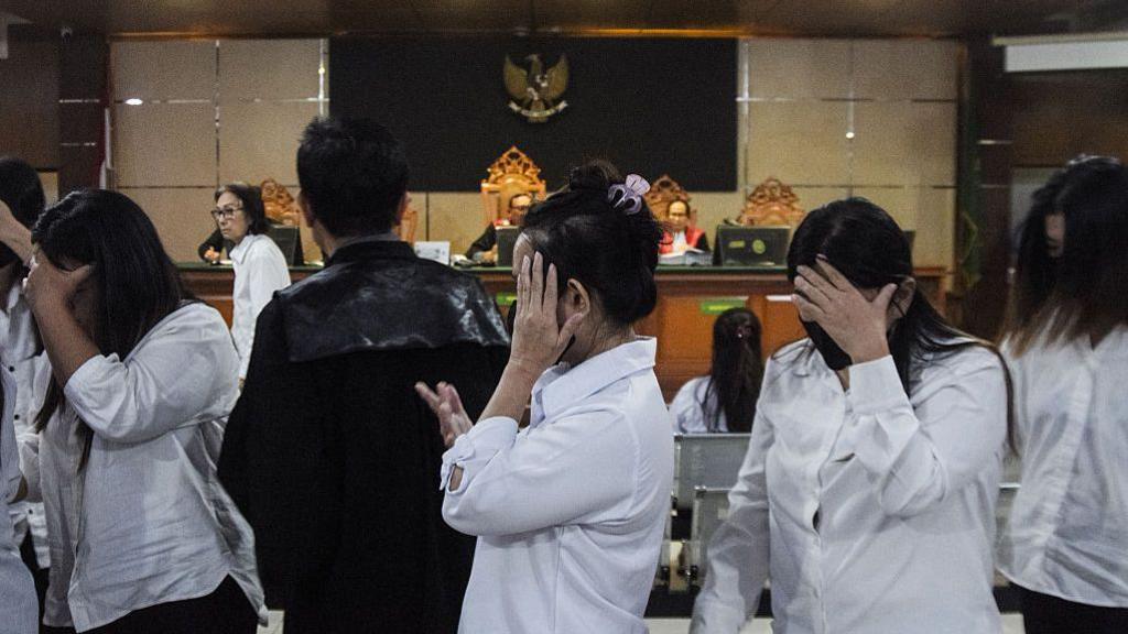 Defendants leave after a trial in a baby trafficking case at the Bandung District Court in Bandung