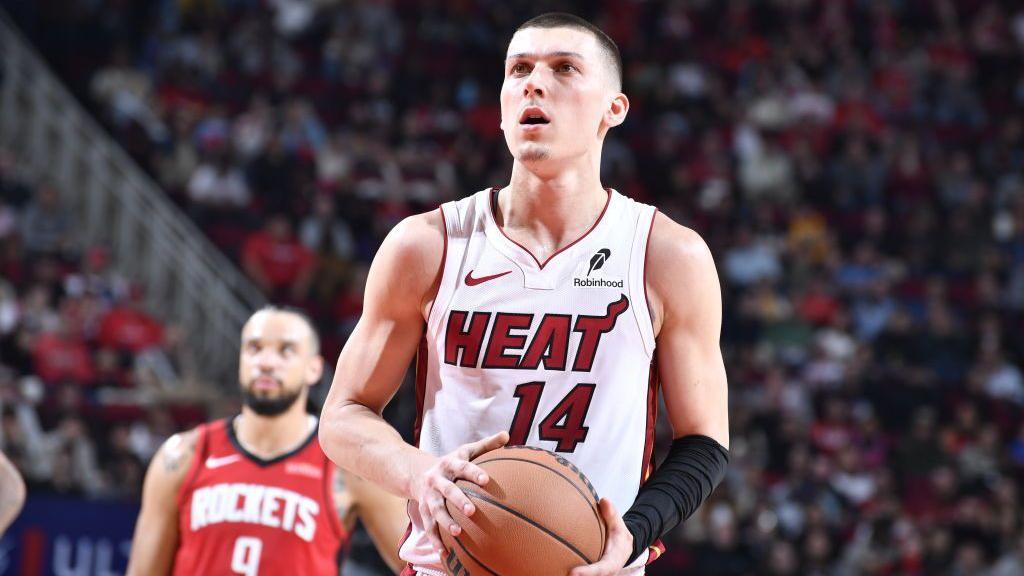 Tyler Herro holding a basketball