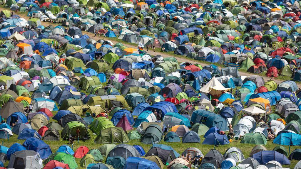 A shot of a crowded campsite at Glastonbury Festival