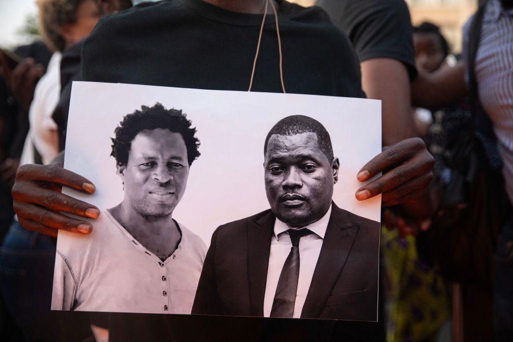 An image is held of Paulo Guambe (L) and advisor and lawyer Elvino Dias (R) both working with Mozambique's leading opposition candidate for the 'Obtimist party for the development of Mozambique' (PODEMOS), is held during a vigil the day after they were shot dead in Maputo October 19, 2024. The lawyer Elvino Dias for Mozambique's leading opposition candidate Venancio Mondlane, who ran for president in October 9 elections, was gunned down in Maputo on October 19. Dias, was killed along with Paulo Guambe after gunmen shot up their car while it was immobile on a road in the centre of the capital, witnesses said. Mozambique is awaiting official nationwide results from the elections. They are due to be published on October 24.