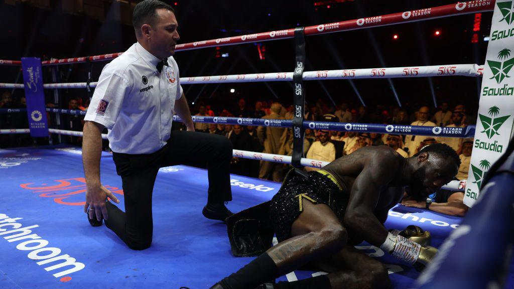 Deontay Wilder on the canvas against Zhilei Zhang
