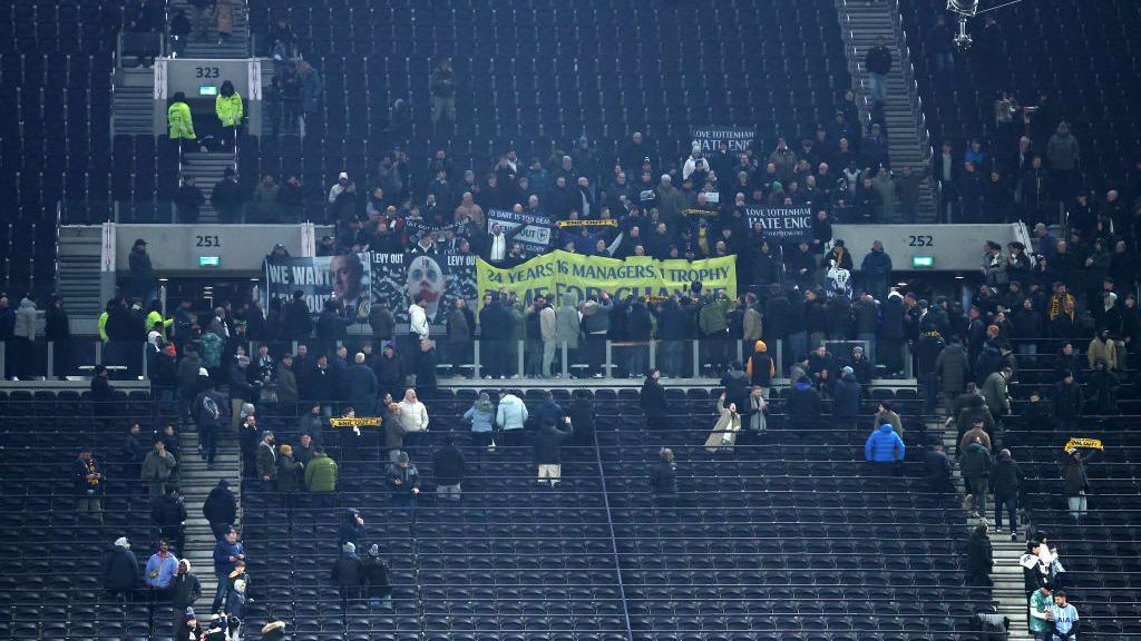 Some supporters stayed behind after the match, staging a sit-down protest