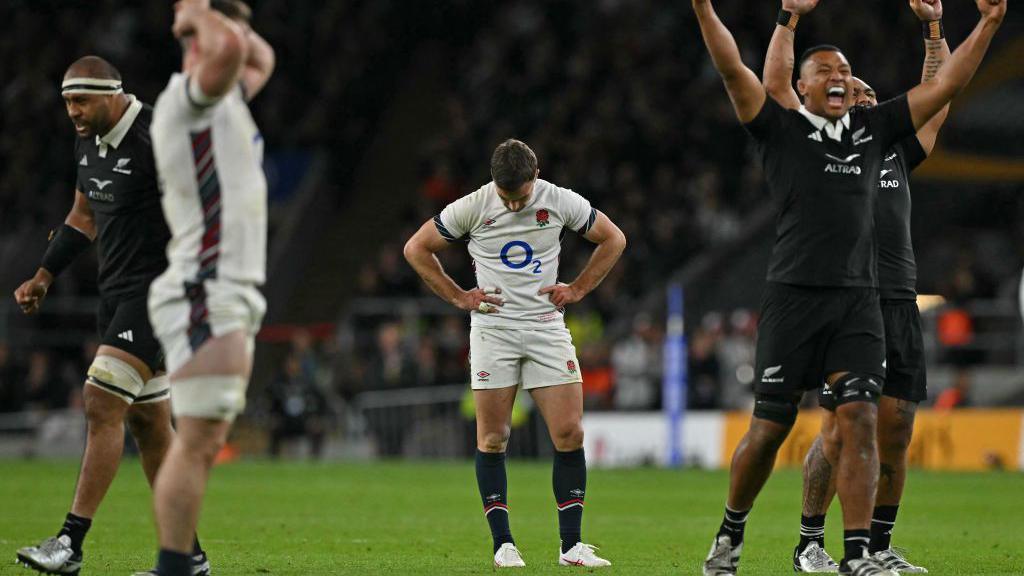 George Ford [centre] reacts after missing a last-play drop-goal attempt, while New Zealand players [right] celebrate beating England