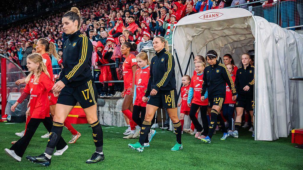 United's players coming out of the tunnel wearing different football boots.