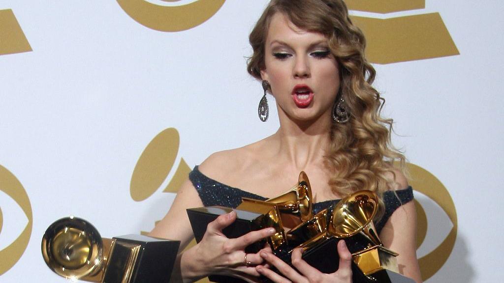Taylor Swift drops one of her awards during the 52nd annual Grammy Awards