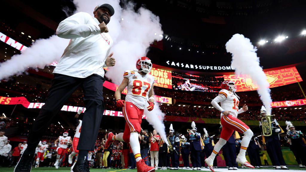 Travis Kelce #87 and Patrick Mahomes #15 of the Kansas City Chiefs take the field 